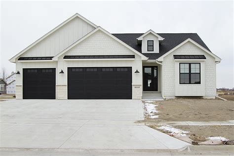 Modern Farmhouse Black Garage Doors / Black Raised Panel Garage Doors on Modern Farmhouse ...