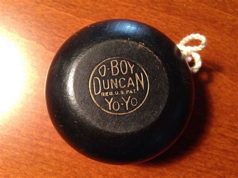 An Old Yoyo Toy Sitting On Top Of A Wooden Table