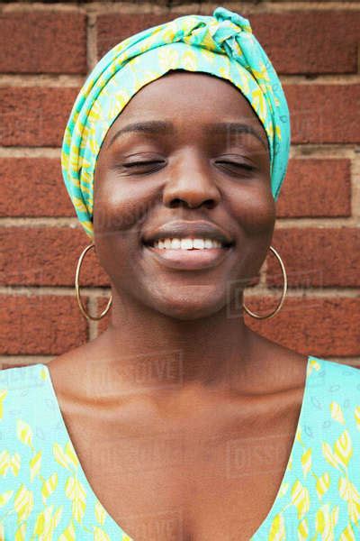 Portrait Of Smiling Black Woman With Eyes Closed Stock Photo Dissolve