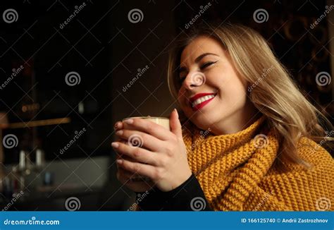 Pretty Blonde Girl In Cafe Enjoys Aroma Of Freshly Ground Coffee In Morning In Restaurant Or