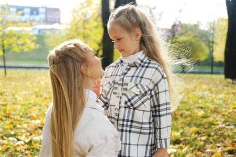 Mother And Daughter Spend Time Together In The Autumn Park Mother