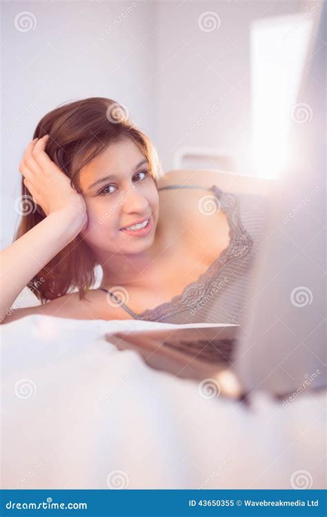 Beautiful Brunette Lying On Bed Using Her Laptop Stock Image Image Of Looking Domicile