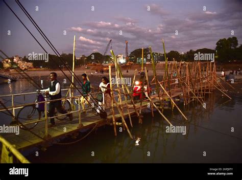 November 28, 2022, Guwahati, Guwahati, India: People cross a bamboo ...