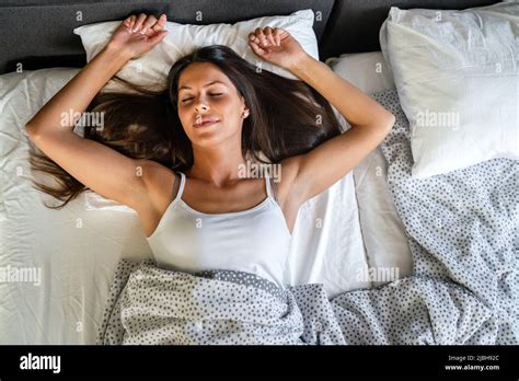 Happy Girl Waking Up Stretching Arms On The Bed In The Morning Stock