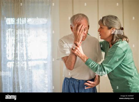 Senior Woman Comforting Her Unwell Husband Stock Photo Alamy