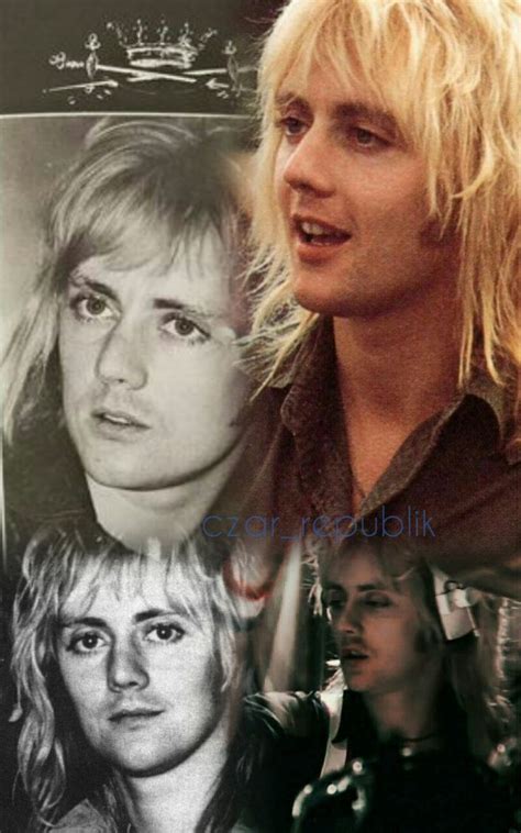 the blond haired man has long hair and is looking at something in front of him