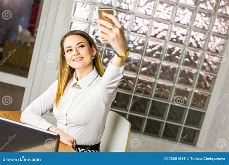 Smiling Business Woman Taking A Selfie In Her Office Using Smart Phone