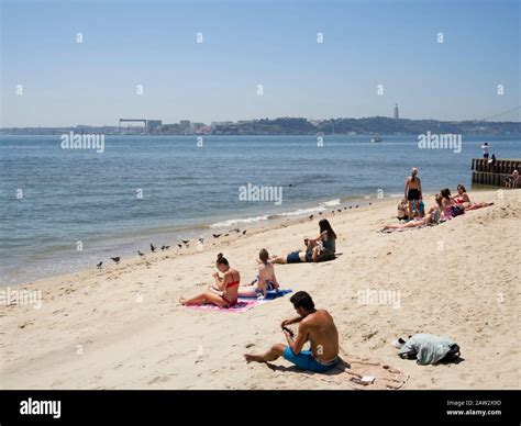 Tourists Sunbathing At The Beach Near Cais Das Colunas Terreiro Do