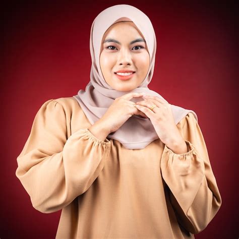 Premium Photo A Woman In A Tan Shirt And Tan Scarf Is Smiling And