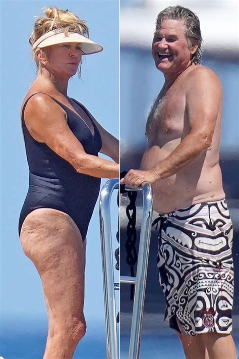 Two People Standing On Top Of A Boat Next To Each Other Wearing Swimsuits