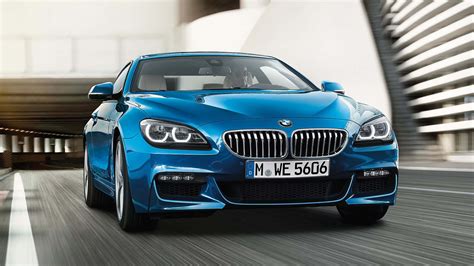 Download Sleek Bmw 6 Series In A Vibrant Urban Setting Wallpaper