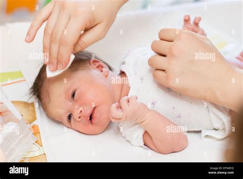 Mother Cleaning Newborn Baby Skin Stock Photo Alamy