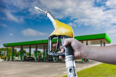 Man Holds A Refueling Gun In His Hand For Refueling Cars Gas Station