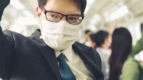 Premium Photo Young Man Wearing Face Mask Travels On Crowded Subway Train