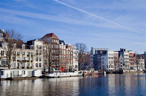 "Amstel River In Amsterdam With Buildings" by Stocksy Contributor "Rene ...