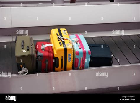 Colorful Suitcases Luggage On Airport Baggage Claim Conveyor Stock