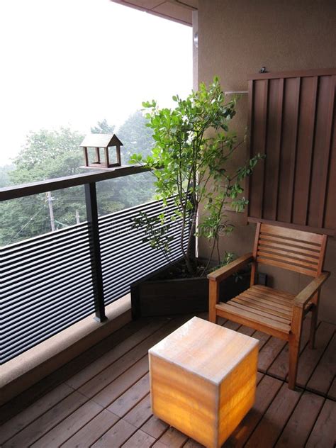 Balcony With Wooden Chair Tree Plant And Lantern Lamp Table At The