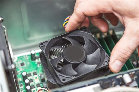 Premium Photo | Technician hands installing cpu cooler fan on a computer pc motherboard