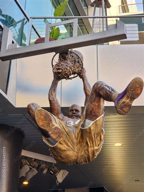 A Statue Of Shaquille O Neal Dunking A Basketball A Lakers Uniform In