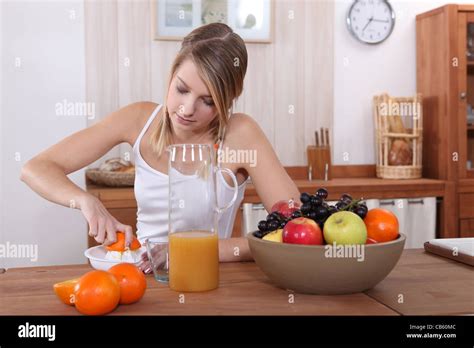 Cute Blonde Pressing Orange For Breakfast Stock Photo Alamy