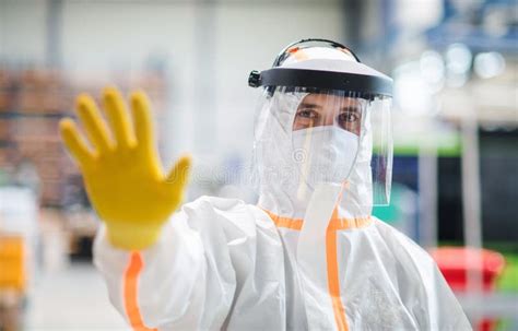 Worker With Protective Mask And Suit In Industrial Factory Stop Sign