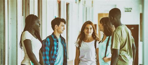 Multi Race Classroom Having Relaxed Conversation In Schoolyard Stock