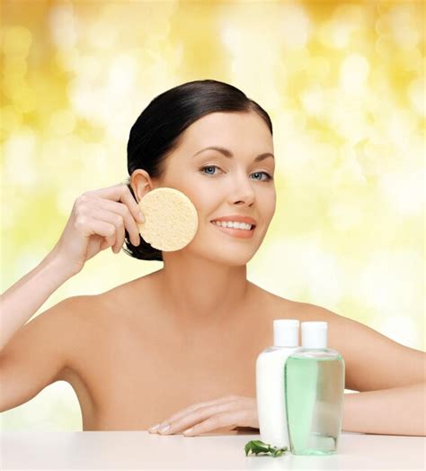 Premium Photo Health Spa And Beauty Concept Smiling Woman With Sponge And Cosmetic Bottles