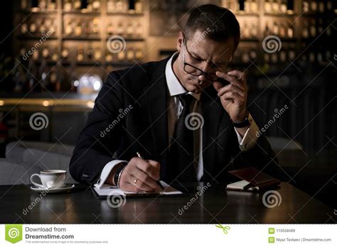 An Elegant Serious And Concentrated Businessman Sitting In Modern