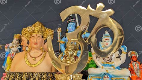 Hindu Gods And Goddess Statues In Focus Behind Brahman Aum Symbol Stock