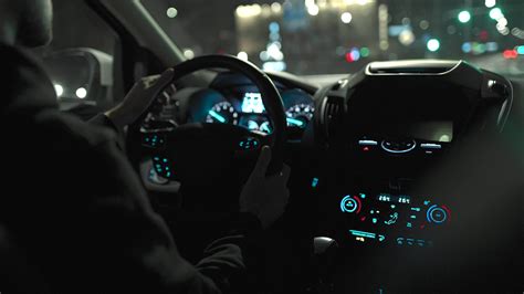 Man Driving Car Through The Streets Of Night City View From The Back