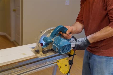 Carpenter Using Circular Saw For Cutting Boards With Hand Power Tools