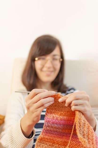 Premium Photo Closeup Of A Woman Hands Knitting A Colorful Scarf With