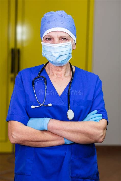 A Doctor Wearing Protective Accessories And A Blue Uniform Stock Photo