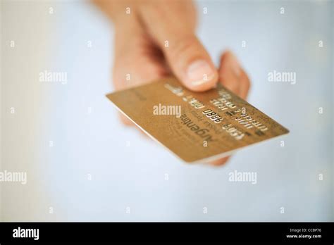 Hand holding credit card, cropped Stock Photo - Alamy