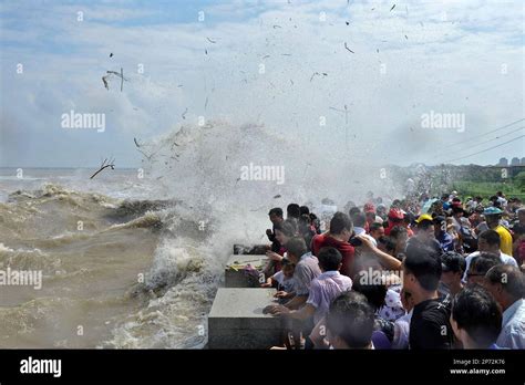 Tourists Crowd To See Tidal Waves Hitting The Bank Of Qiantang River