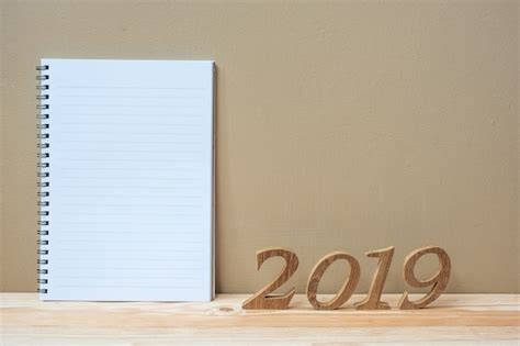 Premium Photo Happy New Years With Notebook And Wooden Number On