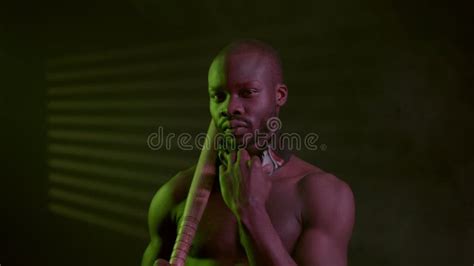 Black Guy With Naked Torso Smokes It Emits Smoke From Which Various Figures Are Formed Stock