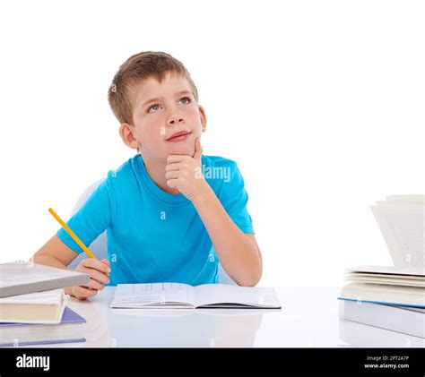 I like studying hard. a young boy doing his homework while deep in thought Stock Photo - Alamy