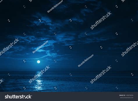 This Photo Illustration Of A Deep Blue Moonlit Ocean At Night With Calm