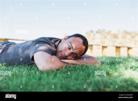 Mature Man Lying On Grass Against Clear Sky Stock Photo Alamy