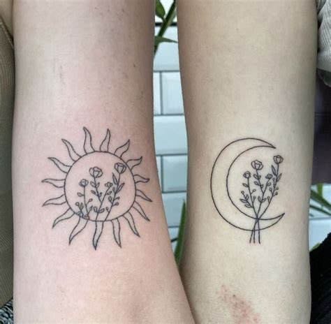 Two Sun And Moon Tattoos On Both Arms With Flowers In The Middle One Is