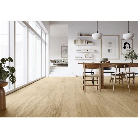 A Dining Room With Wood Floors And White Walls