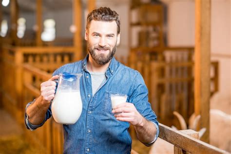 Premium Photo Portrait Of A Handsome Farmer With Fresh Milk Standing