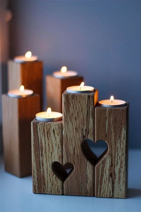 Wooden Candles With Hearts On Them Sitting In Front Of A Blue Wall And