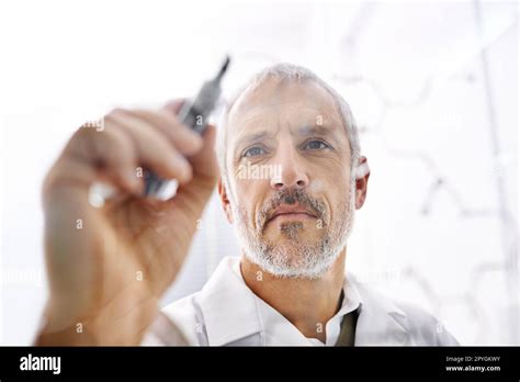 Back To The Drawing Board A Mature Male Scientist Drawing The