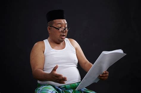 Premium Photo Shocked Mature Man Reading Paper Against Black Background