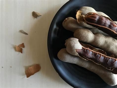 Premium Photo High Angle View Of Tamarind Shells In Plate On Table