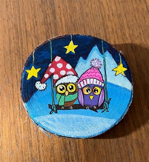 Two Owls Sitting On A Swing In The Night Sky Painted On A Wood Slice