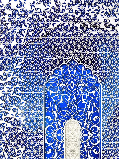 An Intricate Blue And White Tile Wall With A Door In The Middle