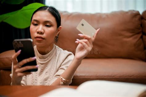 Gorgeous Millennial Asian Female Using A Mobile Banking Application To Pay Her Shopping Bills